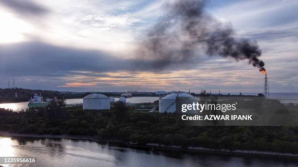 Flare tower emitting fire and smoke is seen from a Perta Arun Gas facility in Lhokseumawe, Aceh on October 18, 2021.