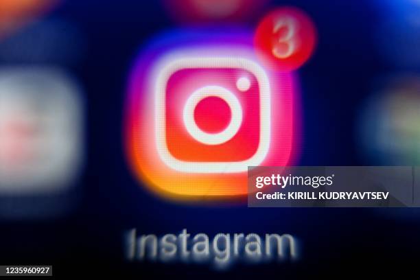 Picture taken on October 18, 2021 in Moscow shows the US social network Instagram's logo on a tablet screen.