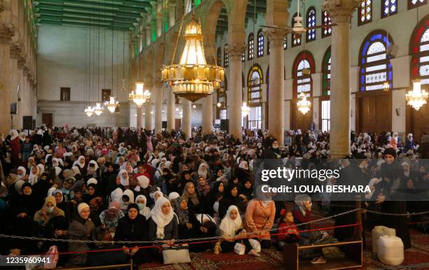 Syrian women pray at the Umayyad Mosque in Damascus, on the eve of celebrations marking the birth of the Prophet Mohammed, known in Arabic as the...