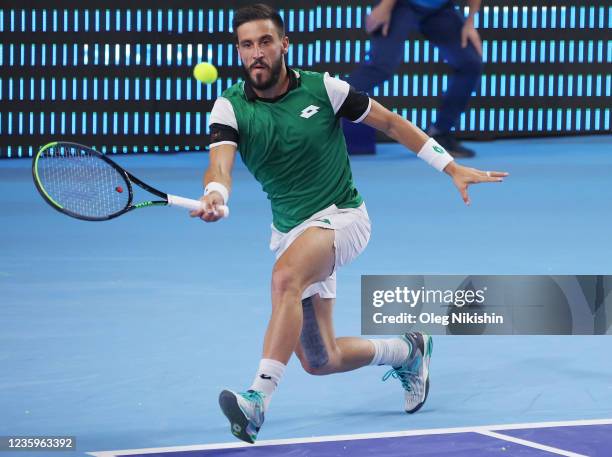 Damir Dzumhur of Bosnia and Herzegovina plays a shot against Marin Cilic of Croatia during on Day One of the VTB Kremlin Cup on the Central Court of...