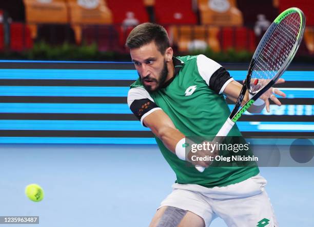 Damir Dzumhur of Bosnia and Herzegovina plays a shot against Marin Cilic of Croatia during on Day One of the VTB Kremlin Cup on the Central Court of...