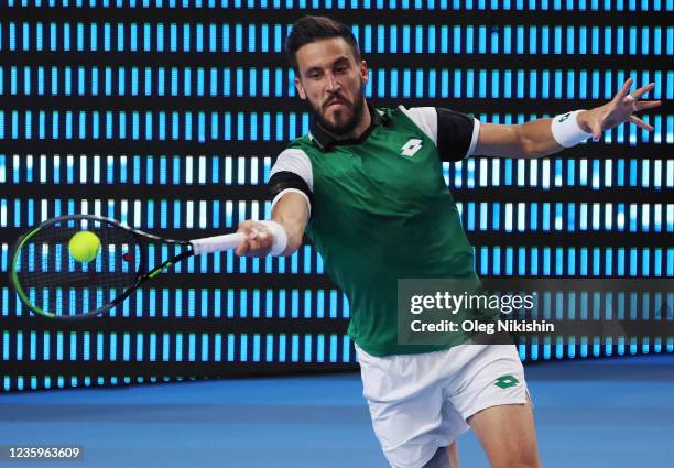 Damir Dzumhur of Bosnia and Herzegovina plays a shot against Marin Cilic of Croatia during on Day One of the VTB Kremlin Cup on the Central Court of...