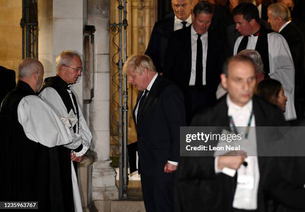 British Prime Minister Boris Johnson speaks with Archbishop of Canterbury, The Most Revd Justin Welby as he leaves a memorial service for Sir David...