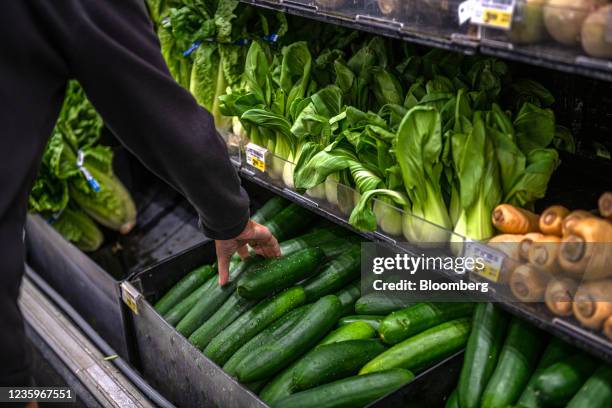 Customer picks out vegetables for sale at a Albertsons Cos. Brand Safeway grocery store in Scottsdale, Arizona, U.S., on Monday, Oct. 18, 2021....