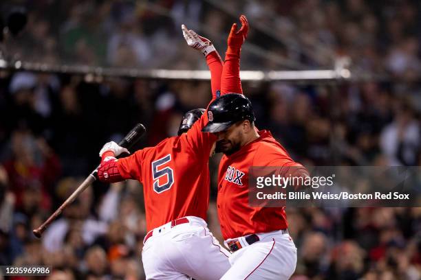 Kyle Schwarber of the Boston Red Sox reacts with Enrique Hernandez after hitting a grand slam home run during the second inning of game three of the...