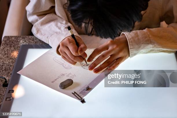 This picture taken on June 17, 2021 shows a student drawing at the anime school Sasayuri in Tokyo. - Japan is facing a shortage of skilled animators,...