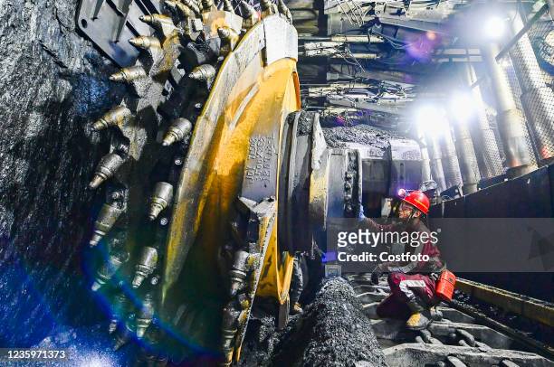 Worker overhauls a coal shearer at a coal mine in Ejin Horuo Banner, Ordos city, Inner Mongolia, China, Oct. 19, 2021. As the national important...