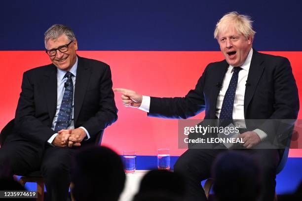 Britain's Prime Minister Boris Johnson jokes with Microsoft founder-turned-philanthropist Bill Gates during a discussion on stage during the Global...