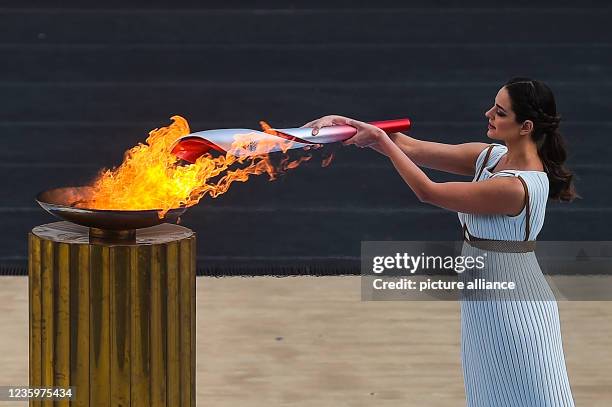 October 2021, Greece, Athen: Xanthi Georgiou, actress from Greece, plays the role of the High Priestess and lights the torch with the Olympic flame...