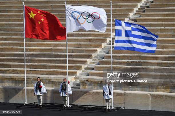 October 2021, Greece, Athen: The Greek flag is taken down during the ceremony for the handing over of the flame for the 2022 Winter Olympics at the...