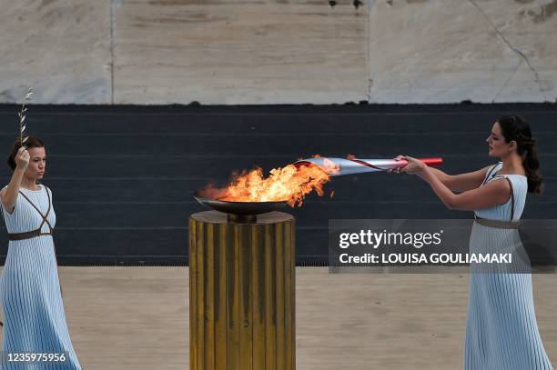 Greek actress Xanthi Georgiou in the role of 'High Priestess', lights the torch with the flame from the cauldron, to pass it over to Chinese...