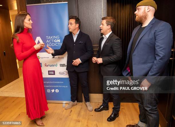 Britain's Catherine, Duchess of Cambridge talks with television presenters Ant McPartlin , Declan Donnelly and Scottish singer-songwriter Tom Walker...