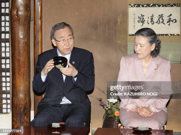 Secretary General Ban Ki-Moon , accompanied by his wife Yoo Soon-taek , drinks a cup of Japanese traditional tea during a welcoming tea ceremony at...