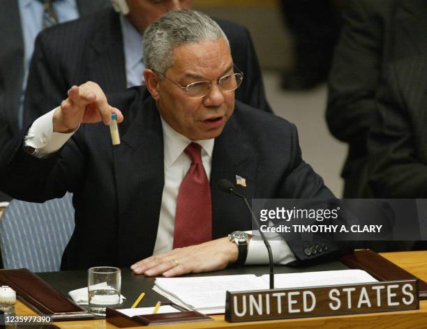 Secretary of State Colin Powell holds up a vial that he said was the size that could be used to hold anthrax as he addresses the United Nations...