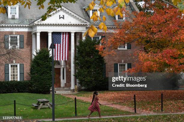 Student walks past the former Sigma Alpha Epsilon fraternity house on the campus of Dartmouth College in Hanover, New Hampshire, U.S., on Friday,...