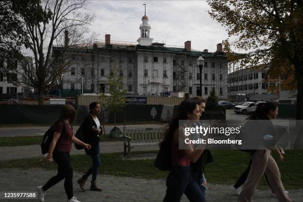 Students walk past Dartmouth Hall, under renovation, on the campus of Dartmouth College in Hanover, New Hampshire, U.S., on Friday, Oct. 15, 2021....