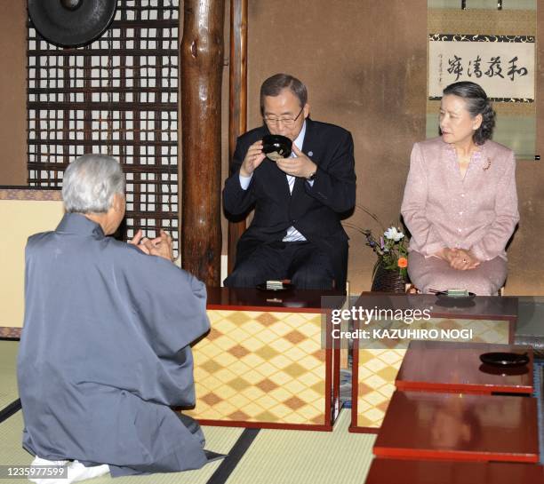 Secretary General Ban Ki-Moon , accompanied by his wife Yoo Soon-Taek , drinks a cup of Japanese traditional tea made by Sen Genshitsu , former grand...