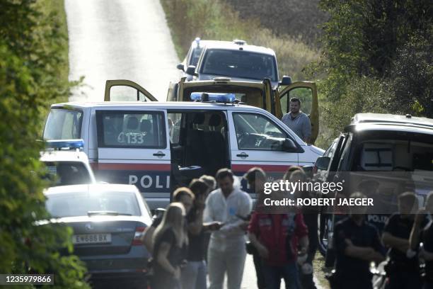 Austrian police are seen near the Austrian-Hungarian border near Siegendorf, Burgenland, Eisenstadt district, on October 19 where two migrants were...