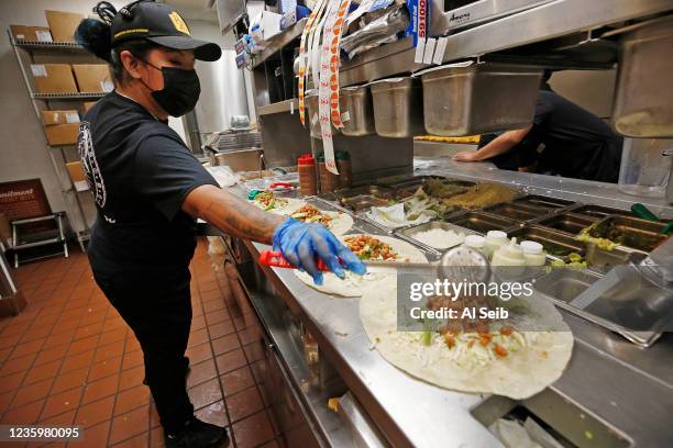 Betzy Gutierrez preparing food orders in the busy kitchen of the El Pollo Loco restaurant in Agoura Hills on August 18, 2021. Michaela Mendelsohn,...