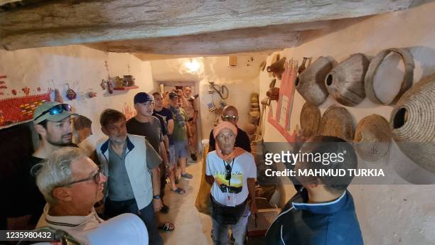 European tourists, escorted by security personnel, visit the old town of Ghadames, a desert oasis some 650 kilometres southwest of the Libyancapital...