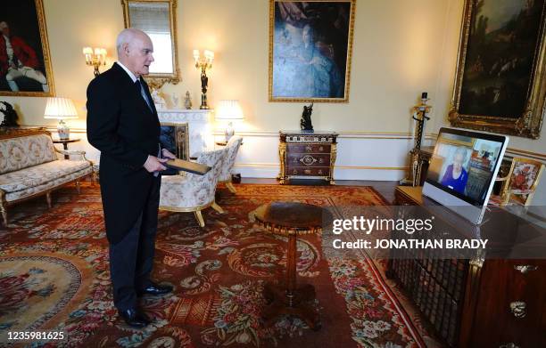 Britain's Queen Elizabeth II appears on a screen via videolink from Windsor Castle, during a virtual audience to receive the European Union's...