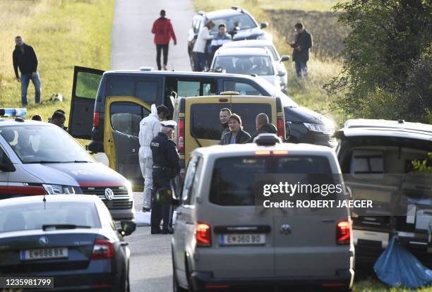 Austrian police are seen near the Austrian-Hungarian border near Siegendorf, Burgenland, Eisenstadt district, on October 19 where two migrants were...