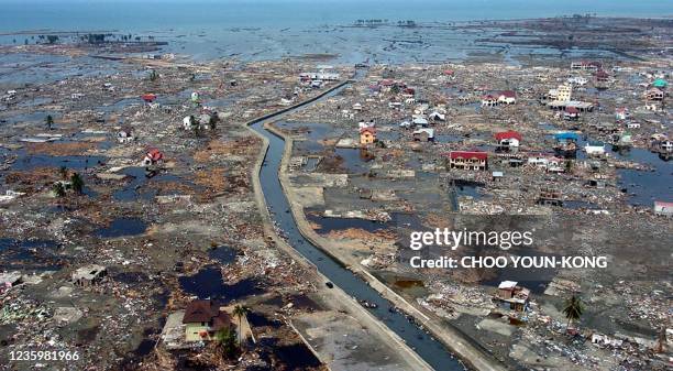 An aerial shot shows flattened houses near the sea coast of Banda Aceh, 05 January 2005. US Secretary of State Colin Powell toured Indonesia's...