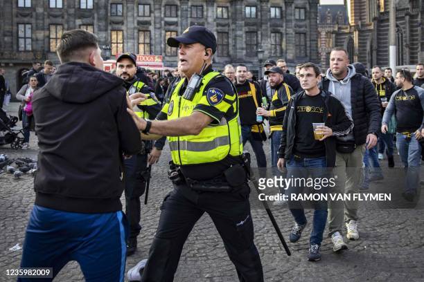 Borussia Dortmund's football fan react with policemen in central Amsterdam on October 19, 2021 before the start of the UEFA Champions League first...
