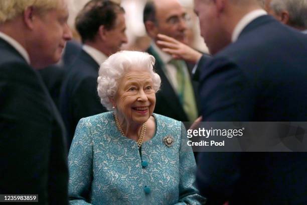 Britain's Queen Elizabeth II and Prime Minister, Boris Johnson greet guests during a reception for international business and investment leaders at...