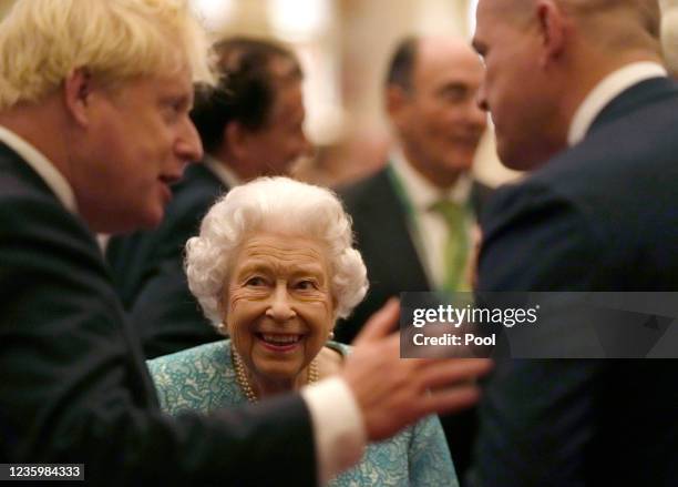 Britain's Queen Elizabeth II and Prime Minister, Boris Johnson greet guests during a reception for international business and investment leaders at...