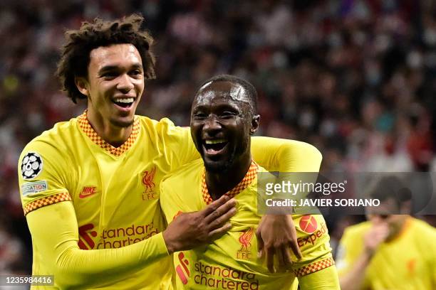 Liverpool's Guinean midfielder Naby Keita celebrates with teammate Liverpool's English defender Trent Alexander-Arnold after scoring a goal during...