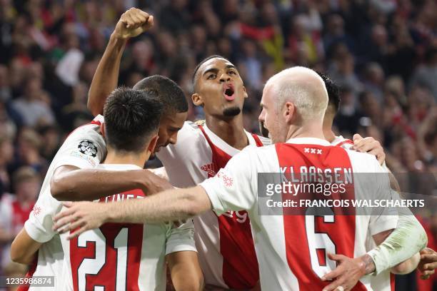 Ajax Amsterdam's Ivorian forward Sebastien Haller celebrates scoring his team's fourth goal with his team mates during the UEFA Champions League...