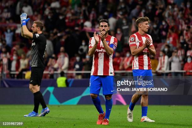 Atletico Madrid's Slovenian goalkeeper Jan Oblak, Atletico Madrid's Spanish midfielder Koke and Atletico Madrid's Spanish midfielder Marcos Llorente...