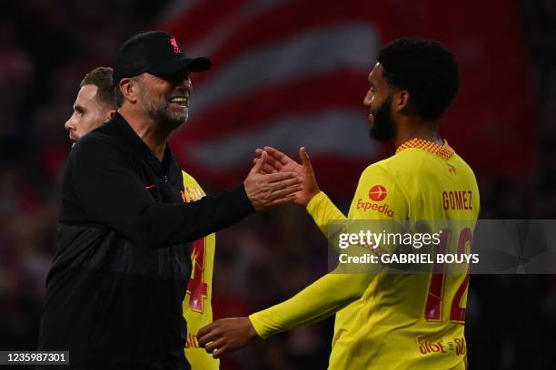 Liverpool's German coach Jurgen Klopp celebrates with Liverpool's English defender Joe Gomez at the end of the UEFA Champions League Group B football...