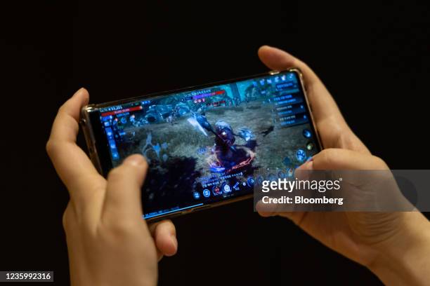 Wemade Co.'s Mir4 mobile game arranged on a smartphone in Seongnam, South Korea, on Wednesday, Oct. 6, 2021. Based on blockchain technology, Mir4...