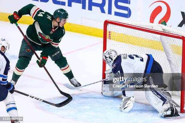 Joel Eriksson Ek of the Minnesota Wild scores the game-winning goal during overtime against the Winnipeg Jets at Xcel Energy Center on October 19,...