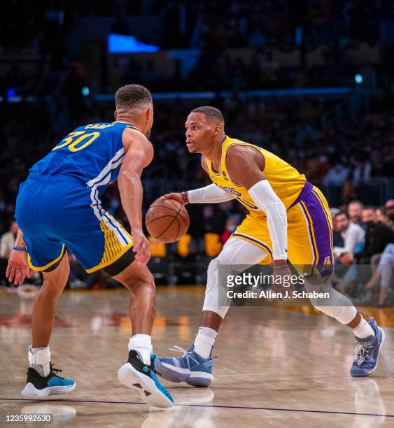 Los Angeles, CA New Los Angeles Lakers guard Russell Westbrook drives to the hoop against Golden State Warriors guard Stephen Curry in the first...