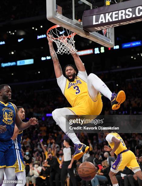 Anthony Davis of the Los Angeles Lakers dunks the ball against Draymond Green of the Golden State Warriors during the second half against at Staples...