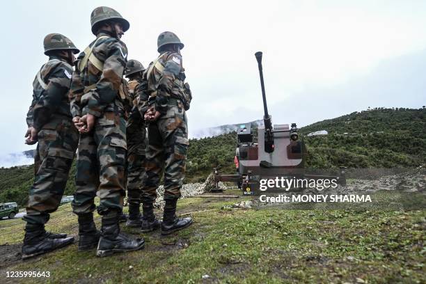 Indian Army soldiers stand next to an upgraded L70 anti aircraft gun in Tawang near the Line of Actual Control , in the northeast Indian state of...