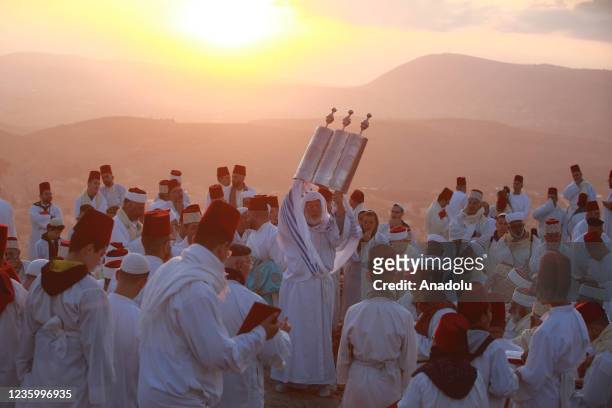 Samaritans, wearing traditional white clothes, gather at Mount Gerizim to celebrate the Sukkot Holiday in Nablus, West Bank, on October 20, 2021. It...