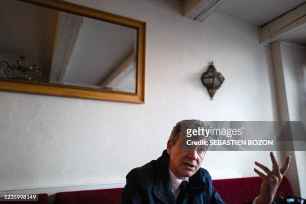 France's former PS Economy Minister and left-wing candidate for the presidential election Arnaud Montebourg gestures in a cafe, prior to attend a...