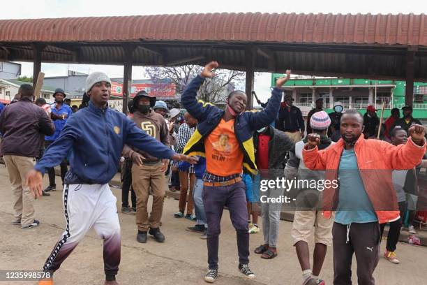 Public transport workers dance and chant political slogans at the bus rank in Manzini on October 19, 2021 as they demand democratic reforms in...