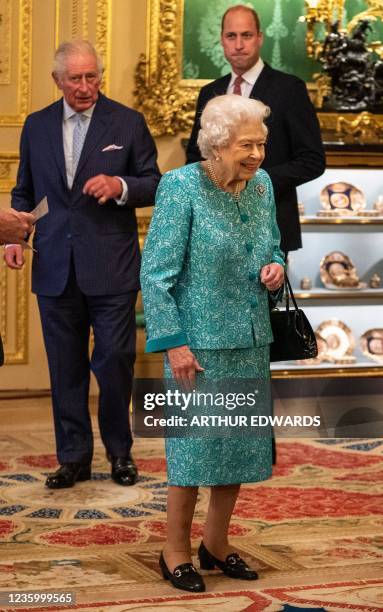 Britain's Queen Elizabeth II attends a reception to mark the Global Investment Summit, at Windsor Castle in Windsor, west of London on October 19,...