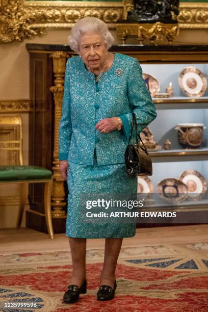 Britain's Queen Elizabeth II attends a reception to mark the Global Investment Summit, at Windsor Castle in Windsor, west of London on October 19,...