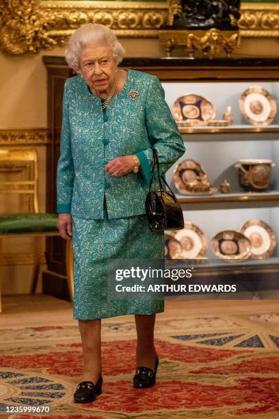 Britain's Queen Elizabeth II attends a reception to mark the Global Investment Summit, at Windsor Castle in Windsor, west of London on October 19,...