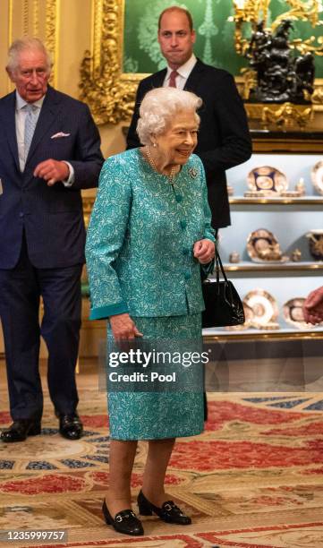 Queen Elizabeth II arrives to greet guests during a reception for international business and investment leaders at Windsor Castle to mark the Global...