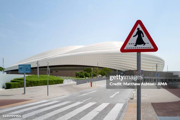 General view an Arabic Crossing road sign in front of the Al Janoub Stadium, Al Wakrah, a host venue for the Qatar 2022 FIFA World Cup. It was...