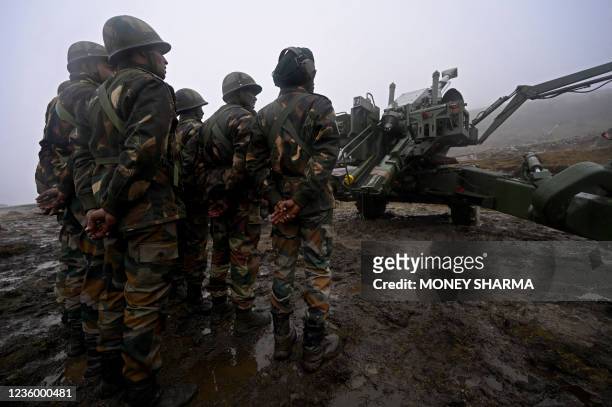 Indian Army soldiers stand next to a Bofors gun positioned at Penga Teng Tso ahead of Tawang, near the Line of Actual Control , neighbouring China,...