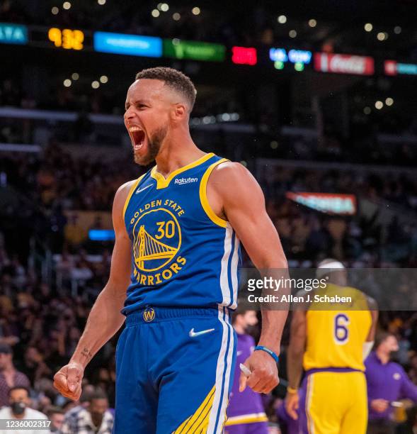 Los Angeles, CA Golden State Warriors guard Stephen Curry, who had 21 points, 10 assists, celebrates as Los Angeles Lakers forward LeBron James walks...
