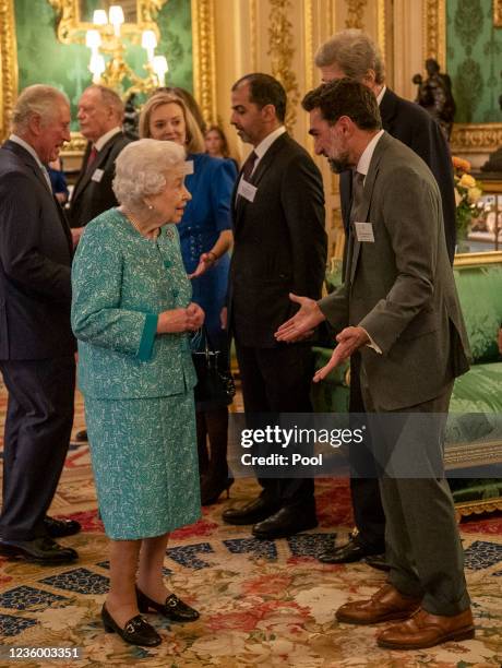 Queen Elizabeth II listens to guest H.E Yasir Othman Al-Rumayyan, Saudi businessman who is Governor of the Public Investment Fund , the sovereign...